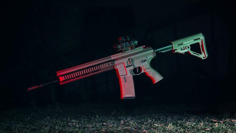 photo of a gun midair on black background